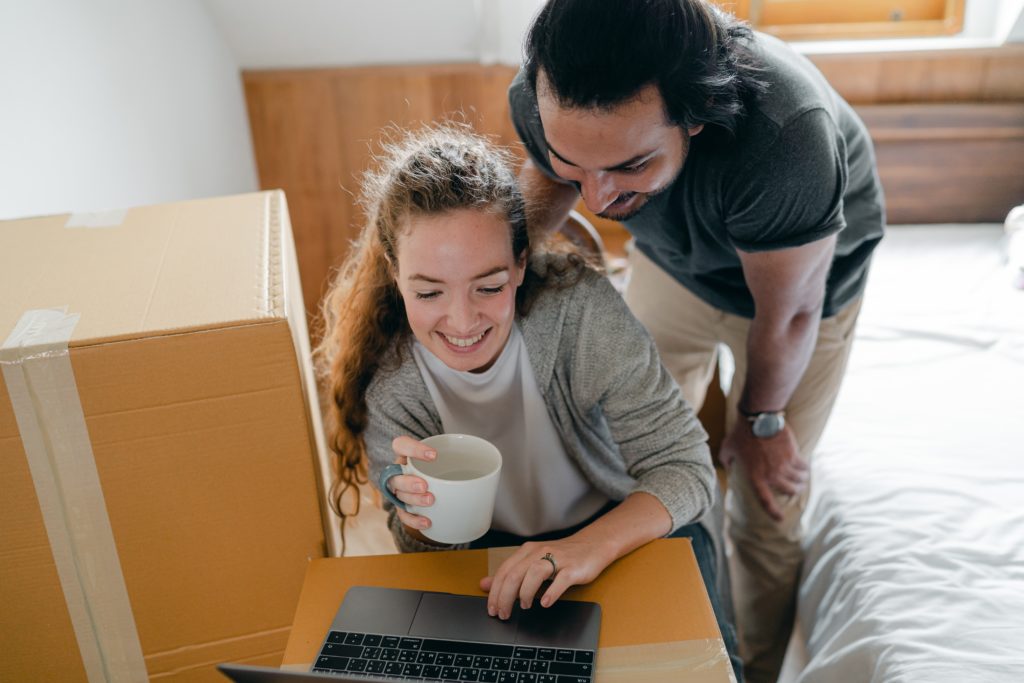 A couple changing address online before moving into a new home.